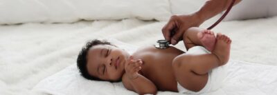 african american baby girl being health checkup with stethoscope